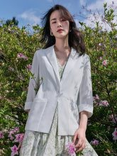 a woman in white blazer